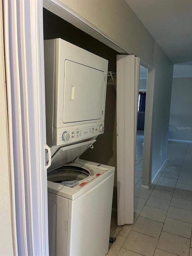 5052 Trekell St, North Port, FL 34287 - laundry room with laundry area, light tile patterned floors, and stacked washer / drying machine