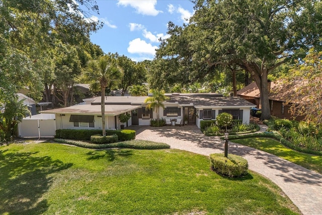 2105 Fosgate Dr, Winter Park, FL 32789 - view of front facade featuring a gate, fence, decorative driveway, and a front yard