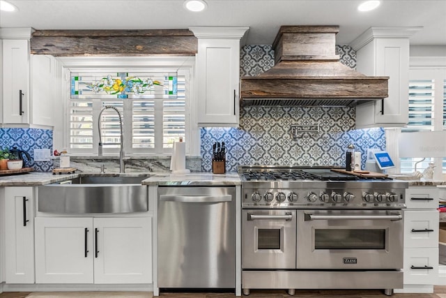 2105 Fosgate Dr, Winter Park, FL 32789 - kitchen with custom exhaust hood, a sink, white cabinets, and appliances with stainless steel finishes