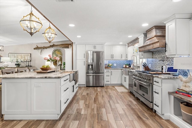 2105 Fosgate Dr, Winter Park, FL 32789 - kitchen featuring light stone counters, a sink, appliances with stainless steel finishes, and white cabinetry