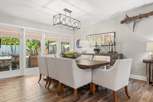 2105 Fosgate Dr, Winter Park, FL 32789 - dining room featuring a chandelier, baseboards, and wood finished floors