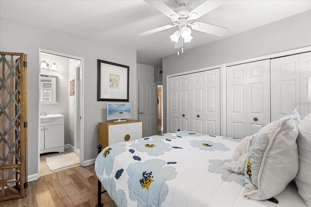 2105 Fosgate Dr, Winter Park, FL 32789 - bedroom featuring two closets, ensuite bath, a ceiling fan, baseboards, and wood finished floors