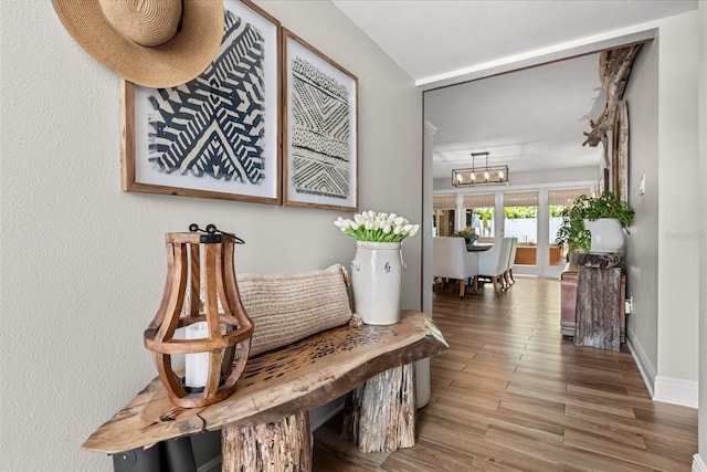 2105 Fosgate Dr, Winter Park, FL 32789 - hall featuring wood finished floors, a notable chandelier, and baseboards