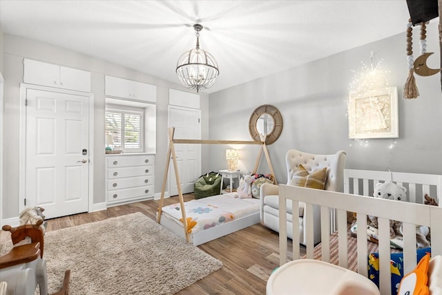 2105 Fosgate Dr, Winter Park, FL 32789 - bedroom featuring wood finished floors and a chandelier