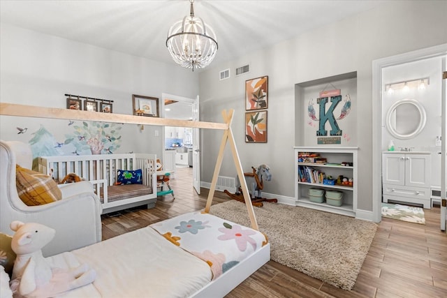 2105 Fosgate Dr, Winter Park, FL 32789 - bedroom with a notable chandelier, visible vents, wood finished floors, and baseboards