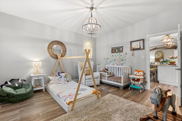 2105 Fosgate Dr, Winter Park, FL 32789 - bedroom featuring a chandelier and wood finished floors