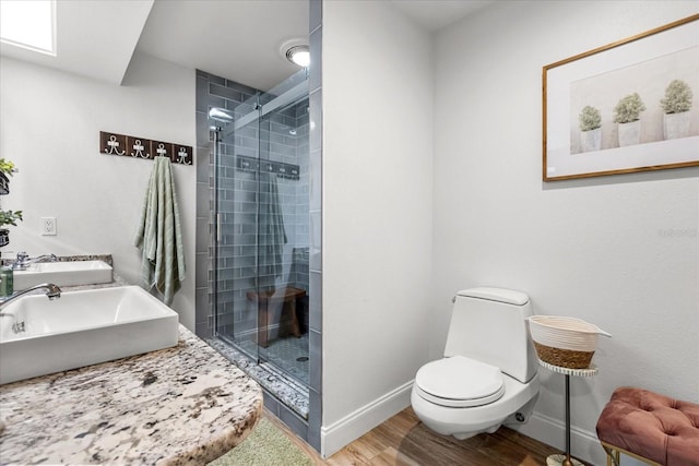 2105 Fosgate Dr, Winter Park, FL 32789 - bathroom featuring baseboards, wood finished floors, toilet, and a stall shower