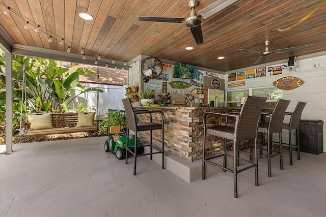 2105 Fosgate Dr, Winter Park, FL 32789 - bar featuring ceiling fan, concrete floors, wood ceiling, a dry bar, and stainless steel fridge with ice dispenser