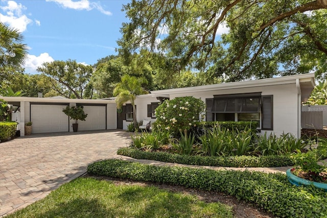 2105 Fosgate Dr, Winter Park, FL 32789 - view of front of home featuring driveway, concrete block siding, and an attached garage