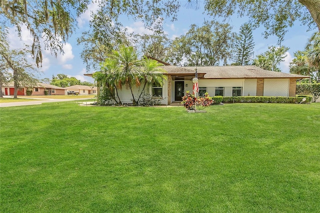 ranch-style house with a front lawn