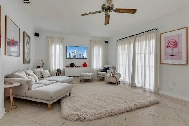 living area featuring light tile patterned floors, baseboards, ceiling fan, and visible vents