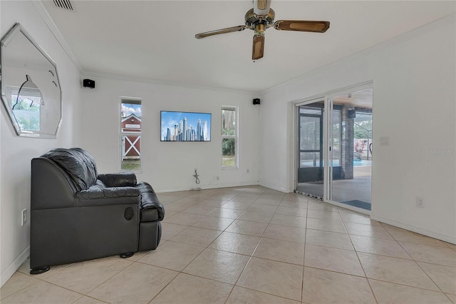 living area featuring ornamental molding, ceiling fan, and a wealth of natural light