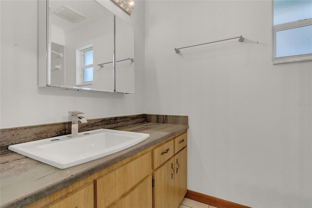 bathroom with ornamental molding and vanity