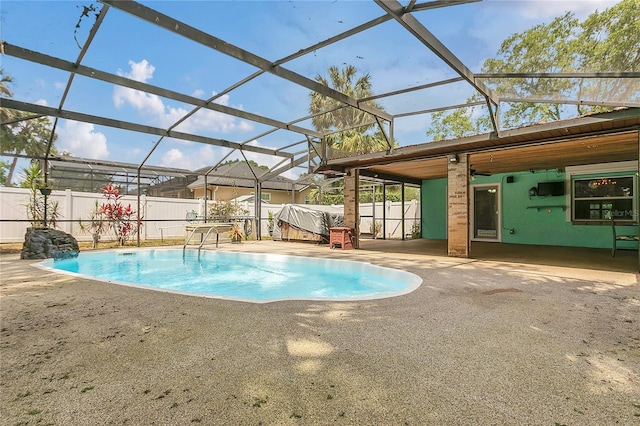 view of swimming pool featuring a fenced backyard, a fenced in pool, a patio area, and glass enclosure