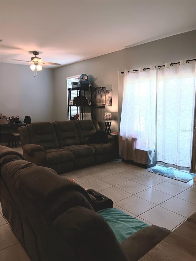 living room featuring a ceiling fan and light tile patterned floors