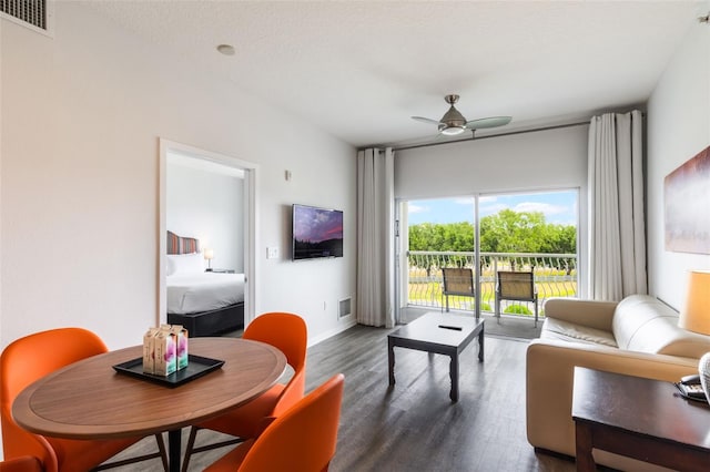225 Celebration Pl Unit 401, Kissimmee, FL 34747 - living area featuring dark wood-style floors, a ceiling fan, and baseboards