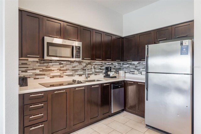 225 Celebration Pl Unit 401, Kissimmee, FL 34747 - kitchen featuring stainless steel appliances, a sink, light countertops, and dark brown cabinets