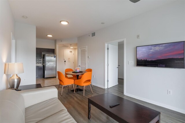 225 Celebration Pl Unit 401, Kissimmee, FL 34747 - living room with light wood-style flooring, baseboards, and recessed lighting