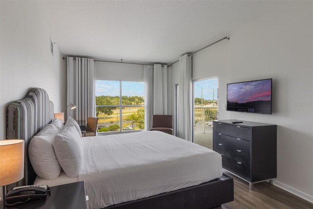 225 Celebration Pl Unit 401, Kissimmee, FL 34747 - bedroom featuring dark wood finished floors, access to outside, and baseboards
