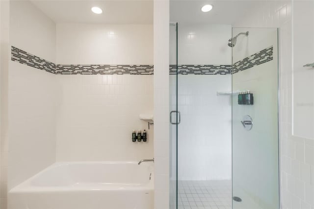 225 Celebration Pl Unit 401, Kissimmee, FL 34747 - bathroom with a shower stall, a tub to relax in, and recessed lighting