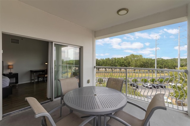 225 Celebration Pl Unit 401, Kissimmee, FL 34747 - balcony with outdoor dining space and view of wooded area