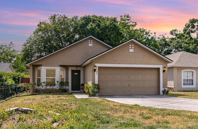 single story home with fence, a front lawn, a garage, stucco siding, and driveway