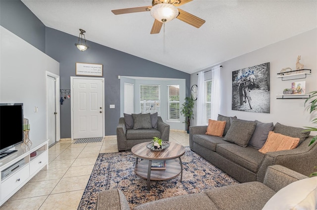 living area with a ceiling fan, light tile patterned flooring, and high vaulted ceiling