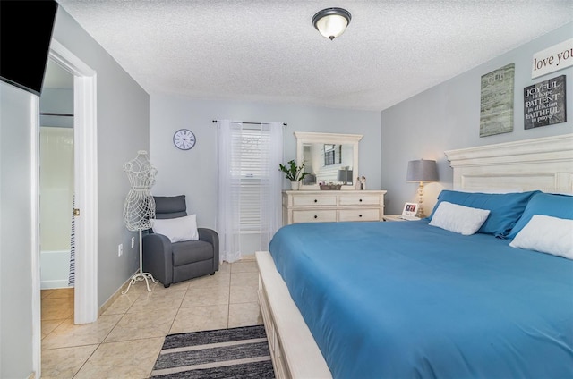 bedroom featuring a textured ceiling and light tile patterned floors