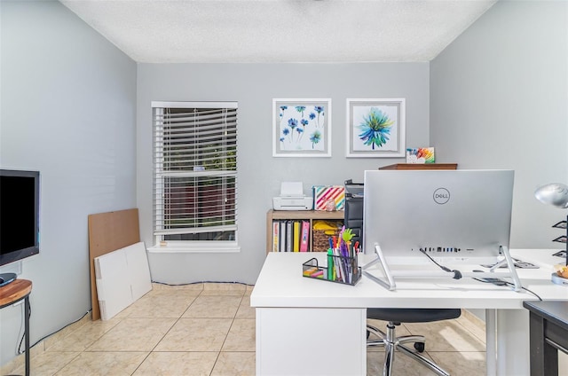 office area with a textured ceiling and light tile patterned floors