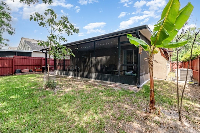 exterior space with a sunroom and a fenced backyard