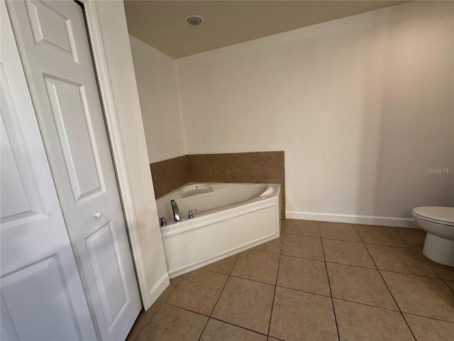 6336 Buford St Unit 307, Orlando, FL 32835 - full bath with tile patterned floors, baseboards, a garden tub, and toilet