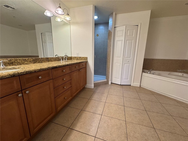 6336 Buford St Unit 307, Orlando, FL 32835 - bathroom featuring a sink, tile patterned floors, double vanity, and a bath