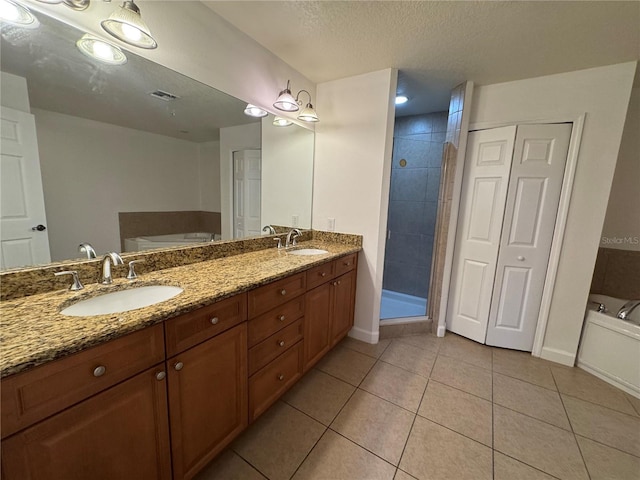6336 Buford St Unit 307, Orlando, FL 32835 - bathroom featuring a sink, tile patterned flooring, double vanity, a tub, and visible vents