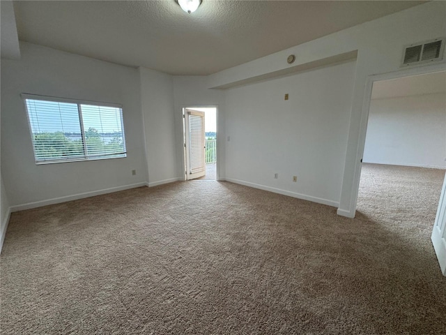 6336 Buford St Unit 307, Orlando, FL 32835 - unfurnished room with visible vents, carpet flooring, and baseboards