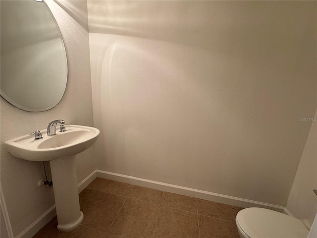 6336 Buford St Unit 307, Orlando, FL 32835 - bathroom featuring baseboards and toilet
