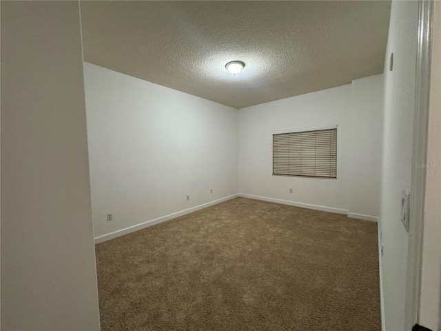 6336 Buford St Unit 307, Orlando, FL 32835 - spare room with baseboards, carpet flooring, and a textured ceiling