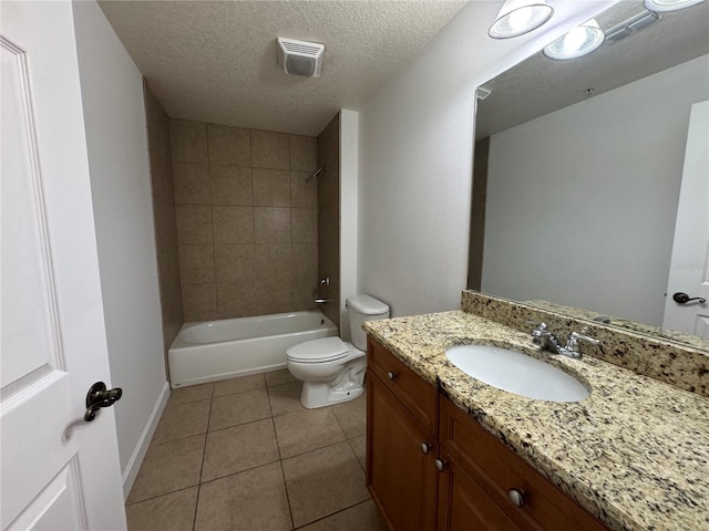 6336 Buford St Unit 307, Orlando, FL 32835 - full bathroom with shower / bath combination, a textured ceiling, tile patterned floors, vanity, and toilet