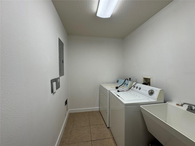 6336 Buford St Unit 307, Orlando, FL 32835 - laundry area with laundry area, light tile patterned flooring, baseboards, washing machine and clothes dryer, and a sink