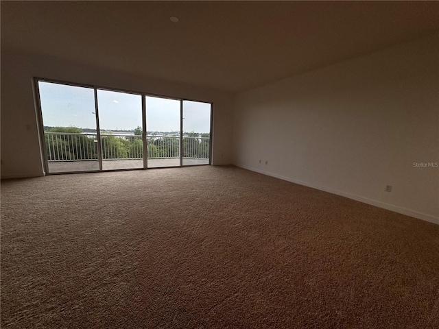 6336 Buford St Unit 307, Orlando, FL 32835 - unfurnished room featuring baseboards and carpet