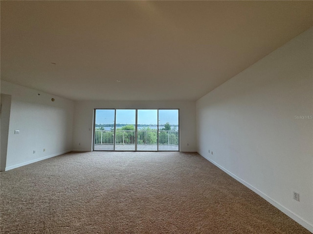 6336 Buford St Unit 307, Orlando, FL 32835 - carpeted spare room featuring baseboards