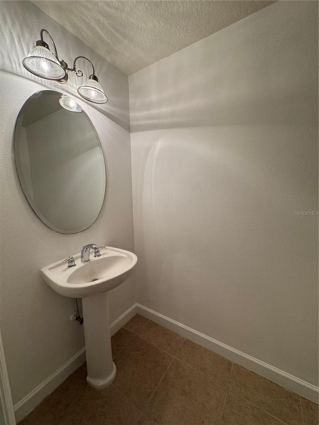 6336 Buford St Unit 307, Orlando, FL 32835 - bathroom with baseboards, tile patterned floors, and a textured ceiling