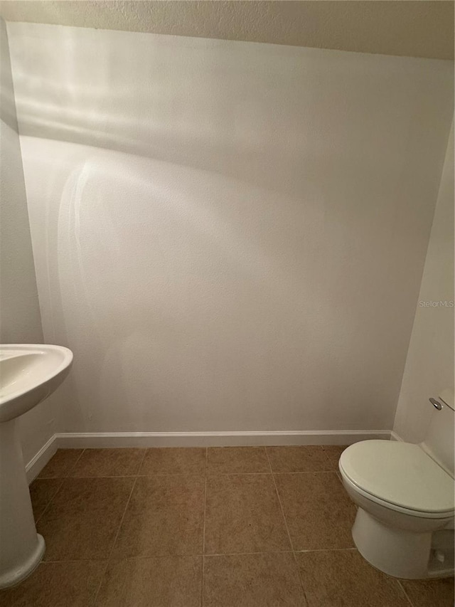 6336 Buford St Unit 307, Orlando, FL 32835 - half bath featuring toilet, baseboards, and tile patterned flooring