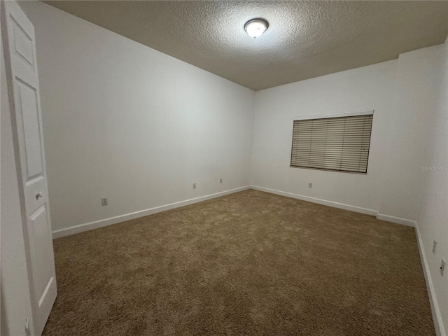 6336 Buford St Unit 307, Orlando, FL 32835 - spare room featuring carpet floors, baseboards, and a textured ceiling