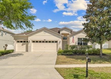 5839 Tarleton Way, Mount Dora, FL 32757 - ranch-style house featuring a garage, driveway, and stucco siding