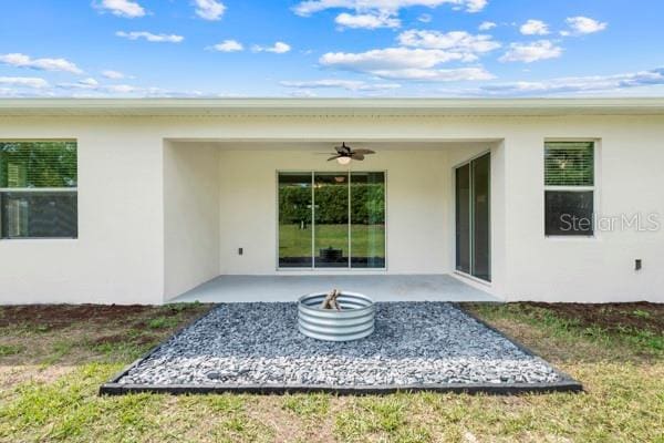 5839 Tarleton Way, Mount Dora, FL 32757 - rear view of property with stucco siding, a ceiling fan, and a patio area