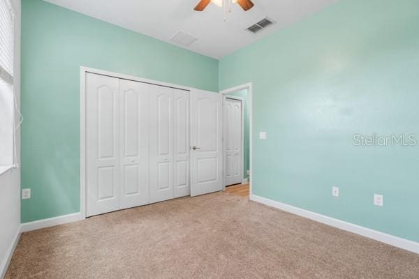 5839 Tarleton Way, Mount Dora, FL 32757 - unfurnished bedroom featuring carpet flooring, baseboards, a closet, and ceiling fan