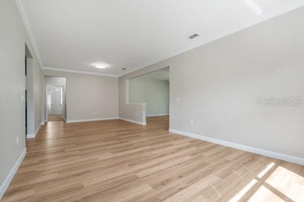 5839 Tarleton Way, Mount Dora, FL 32757 - empty room with ornamental molding, baseboards, and light wood finished floors