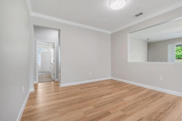 5839 Tarleton Way, Mount Dora, FL 32757 - empty room with crown molding, light wood-style floors, and baseboards