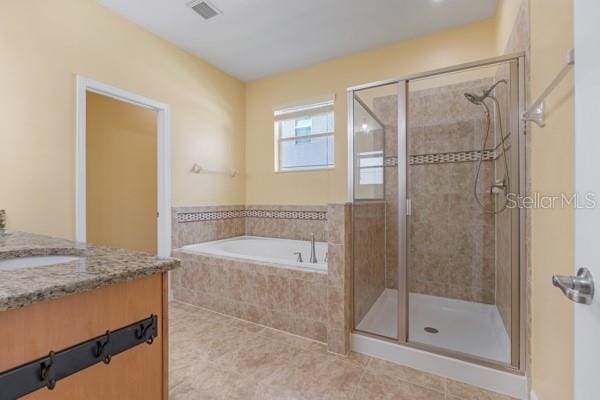 5839 Tarleton Way, Mount Dora, FL 32757 - full bath featuring a stall shower, tile patterned flooring, a garden tub, and vanity