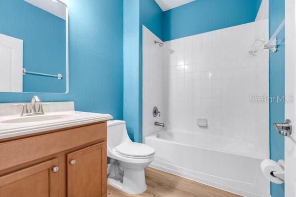 5839 Tarleton Way, Mount Dora, FL 32757 - bathroom featuring toilet, vanity, shower / washtub combination, and wood finished floors